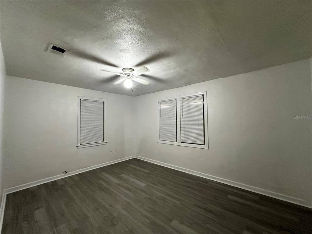 1907 Rio Grande Avenue Orlando, FL 32805 - Photo 13 of 17 an empty room with wooden floor and windows