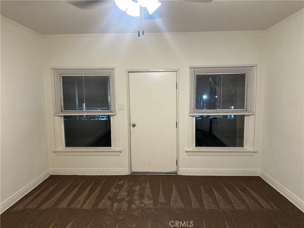 10627 1/2 Garvey Avenue, Unit 6 El Monte, CA 91733 - Photo 1 of 8 an empty room with wooden floor and cabinet