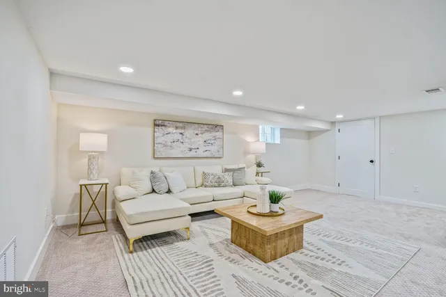 a living room with furniture and a rug