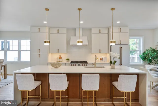 a kitchen with kitchen island granite countertop a table and chairs in it