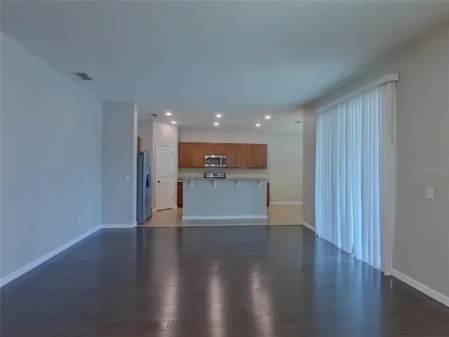 a view of a kitchen with a sink and wooden floor
