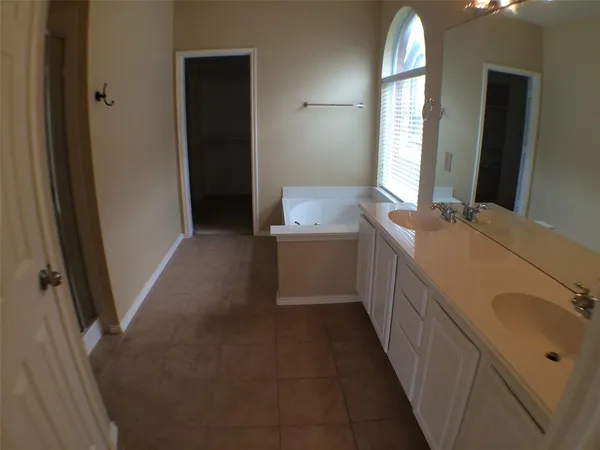 a bathroom with a double vanity sink and a mirror