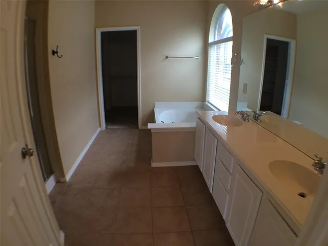 a bathroom with a double vanity sink and a mirror
