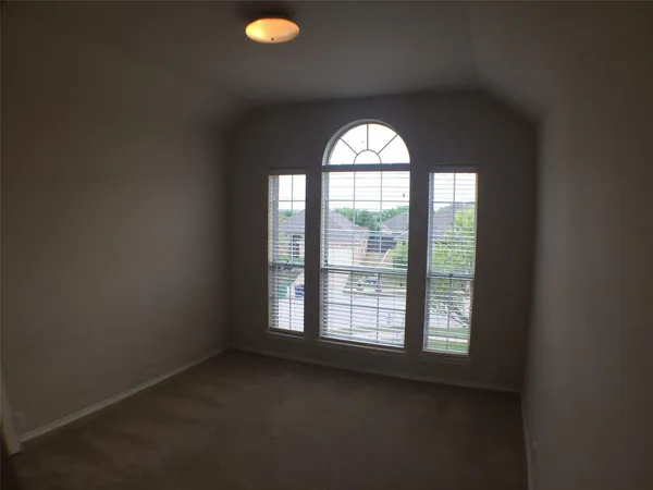 an empty room with windows and city view