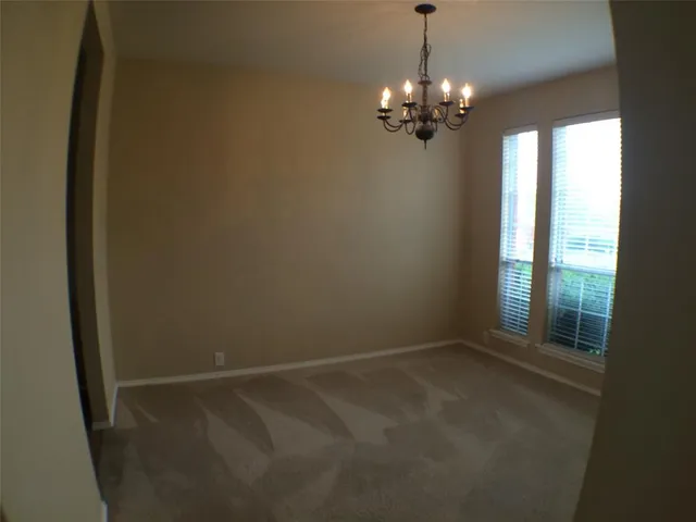 a view of a chandelier in big room and chandelier