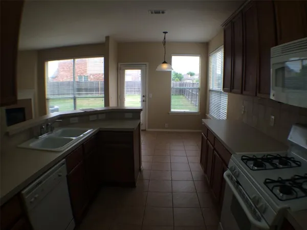 a kitchen that has a sink and a stove