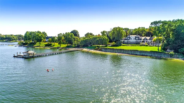 a view of swimming pool with outdoor seating and yard in back