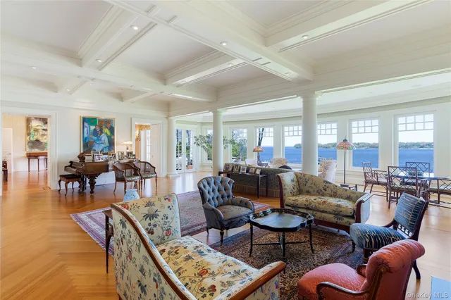 a living room with furniture a fireplace and next to a window