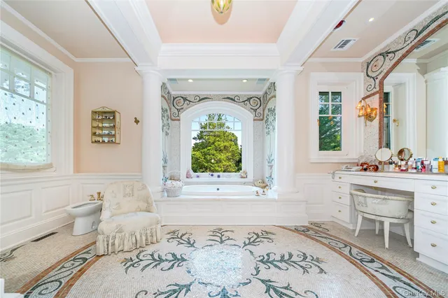 a view of a white house with a big yard and potted plants