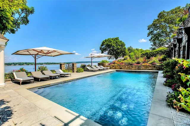 a view of a patio with swimming pool table and chairs