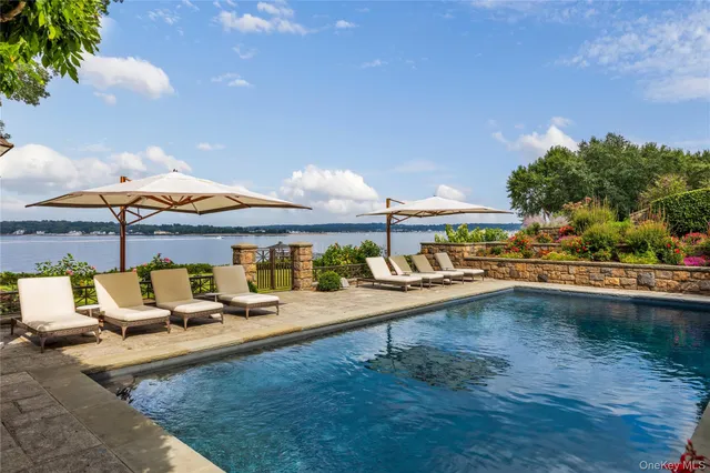 an aerial view of a house with a garden and lake view