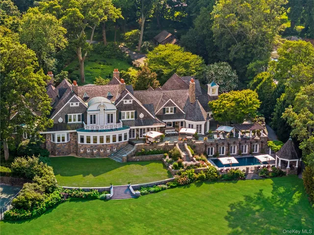 a front view of a house with swimming pool and porch