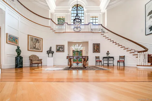 a living room with furniture potted plant and a large window