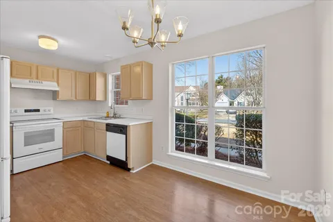 a kitchen with a stove a sink and a refrigerator