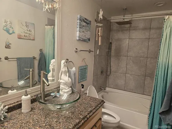 a bedroom with bed and a chandelier