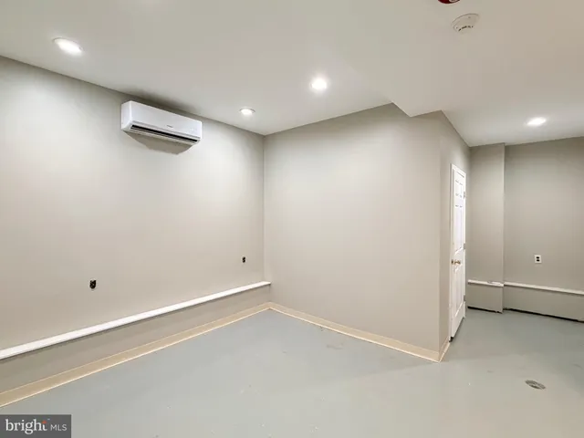 an empty room with a ceiling fan and window