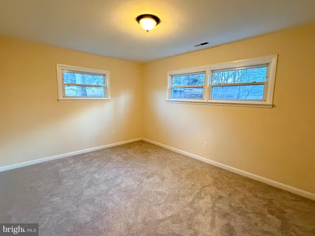 an empty room with a painting on the wall