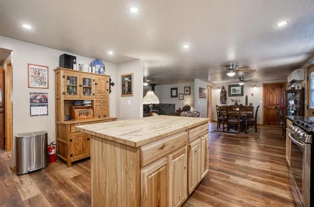 a kitchen with stainless steel appliances kitchen island granite countertop a sink and cabinets