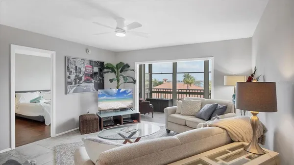 a living room with furniture a rug and a chandelier