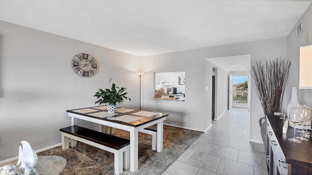 8625 Midnight Pass Road, Unit 506B Sarasota, FL 34242 - Photo 13 of 37 a dining room with furniture and window