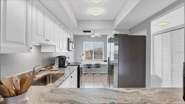 a kitchen with a sink cabinets and a window