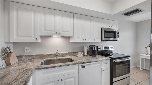 a kitchen with stainless steel appliances a stove a microwave and cabinets