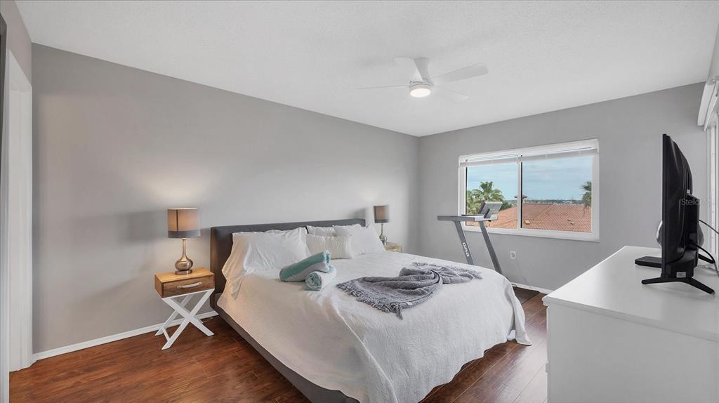 8625 Midnight Pass Road, Unit 506B Sarasota, FL 34242 - Photo 20 of 37 a living room with a bed furniture and a flat screen tv