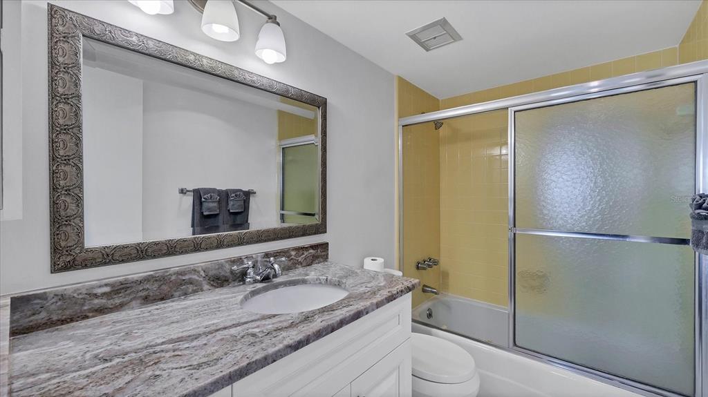 8625 Midnight Pass Road, Unit 506B Sarasota, FL 34242 - Photo 22 of 37 a bathroom with a granite countertop sink toilet and shower