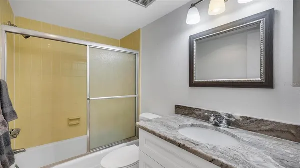 a bathroom with a toilet a sink and a shower