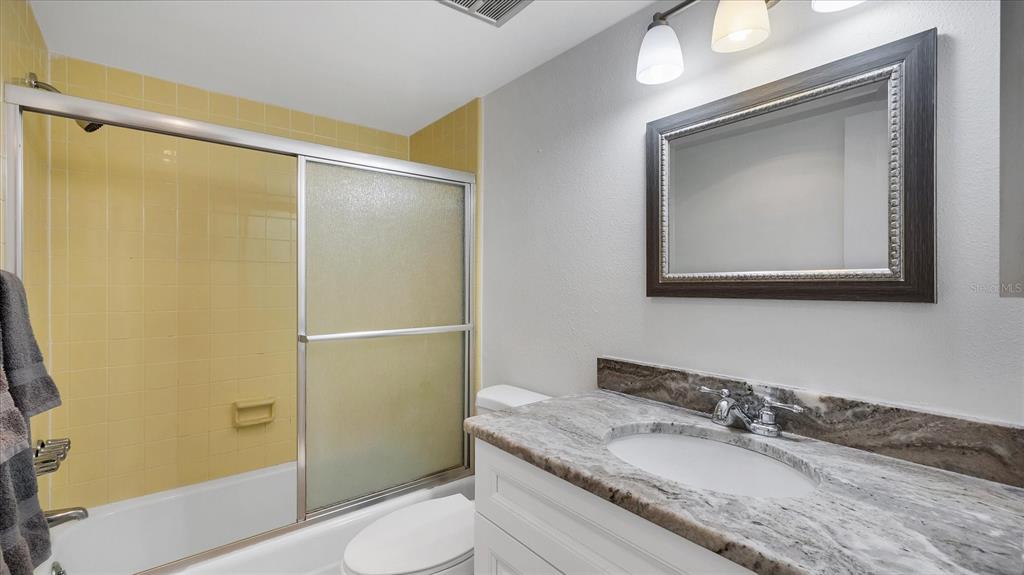 8625 Midnight Pass Road, Unit 506B Sarasota, FL 34242 - Photo 25 of 37 a bathroom with a granite countertop sink toilet and shower