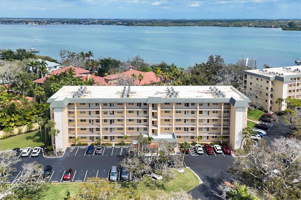 8625 Midnight Pass Road, Unit 506B Sarasota, FL 34242 - Photo 5 of 37 a large building with a lake view