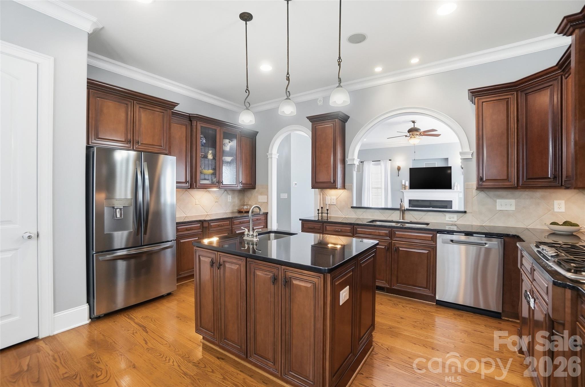3383 Keady Mill Loop Kannapolis, NC 28081 - Photo 11 of 47 a kitchen with stainless steel appliances granite countertop a sink a stove and a refrigerator
