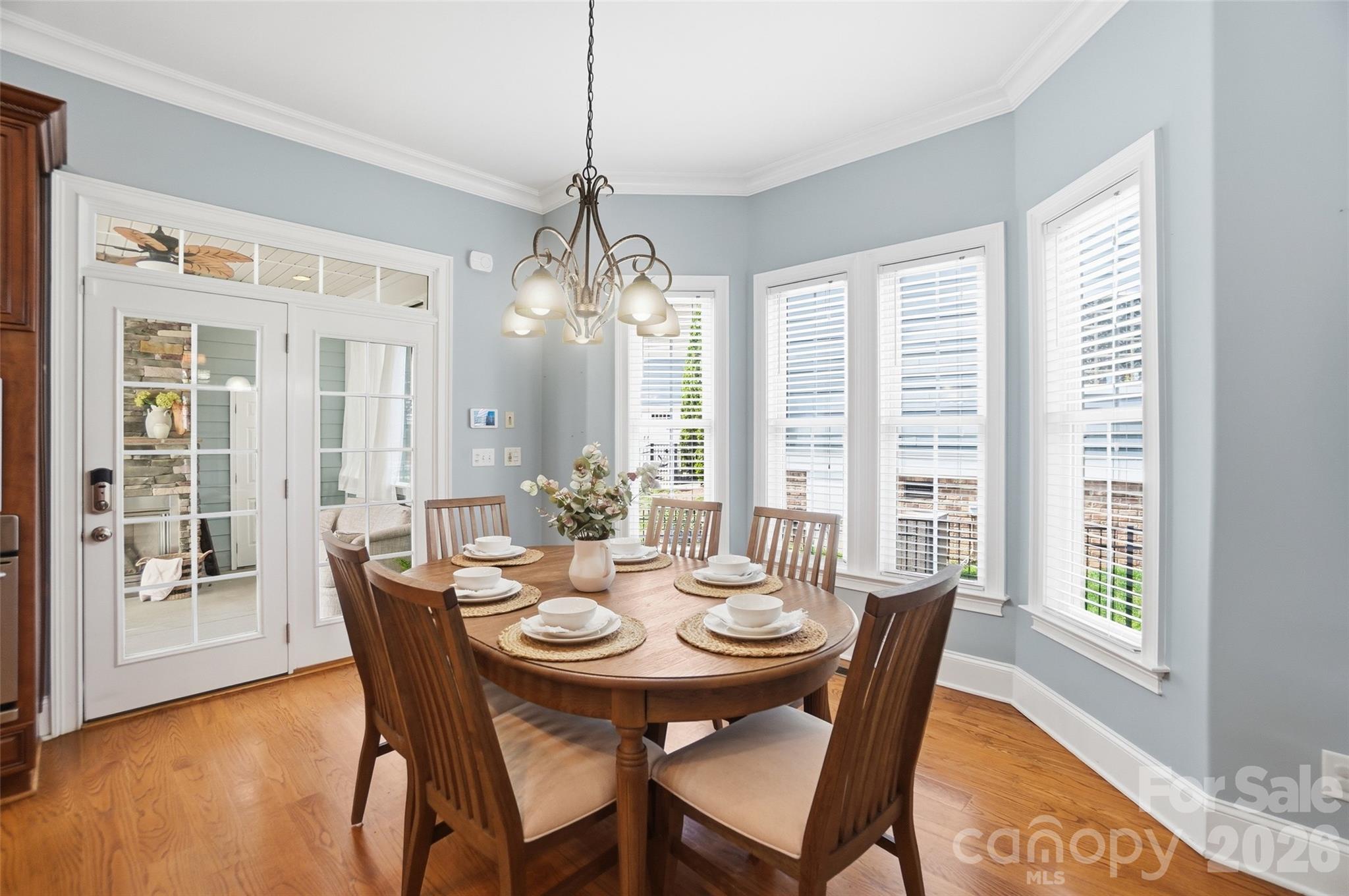 3383 Keady Mill Loop Kannapolis, NC 28081 - Photo 12 of 47 a view of a dining room with furniture wooden floor and chandelier