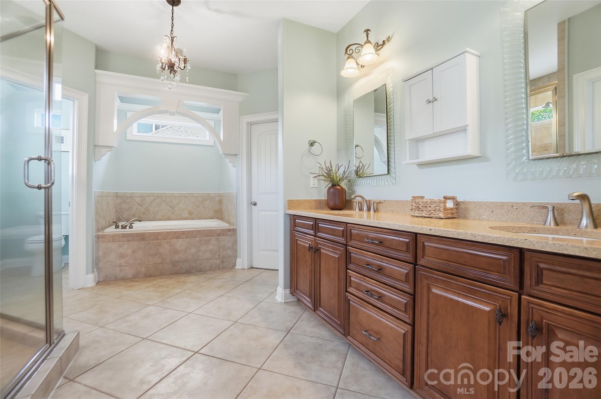 3383 Keady Mill Loop Kannapolis, NC 28081 - Photo 25 of 47 a bathroom with a granite countertop bathtub sink vanity and mirror