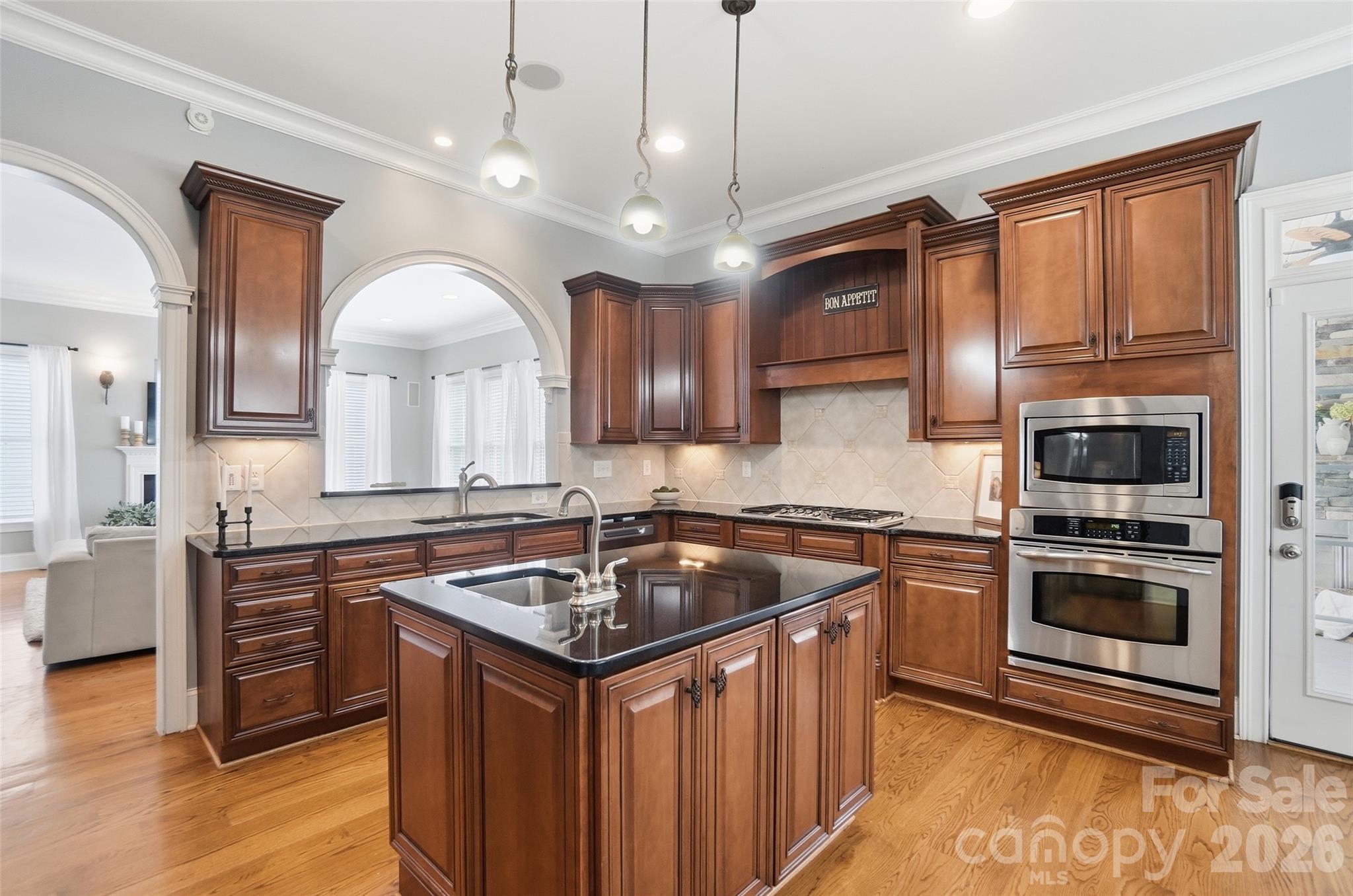 3383 Keady Mill Loop Kannapolis, NC 28081 - Photo 10 of 47 a kitchen with stainless steel appliances granite countertop a sink stove and refrigerator