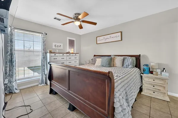 a bedroom with a bed and a ceiling fan