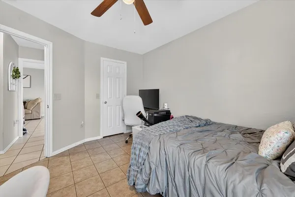 a bedroom that has a bed and chair