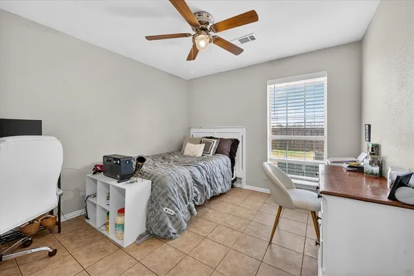 a bedroom with a bed a table and chair