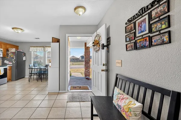 a view of a hallway with furniture and a large window