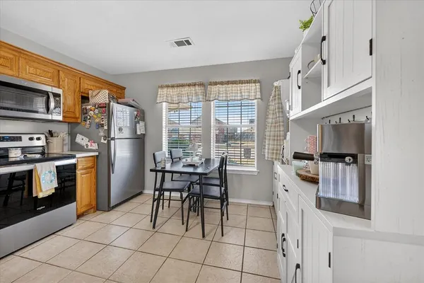 a kitchen with stainless steel appliances a stove a refrigerator and a refrigerator