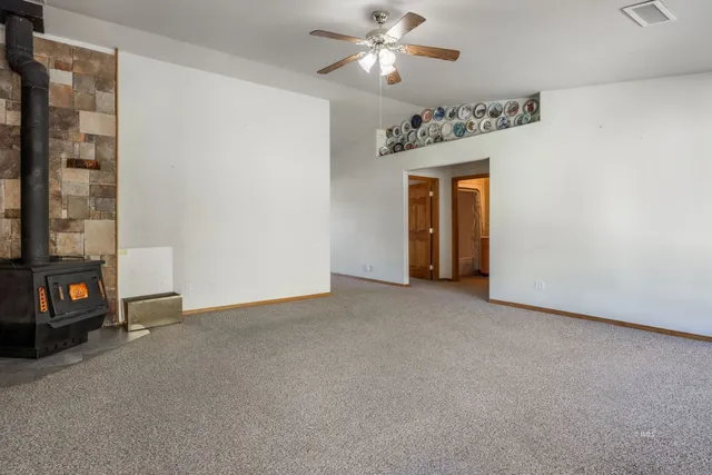 a view of a livingroom with a ceiling fan and window