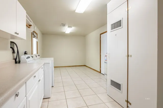 a spacious bathroom with a double vanity sink a mirror and a