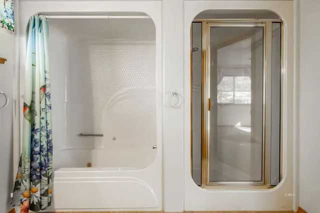 a bathroom with a glass shower door