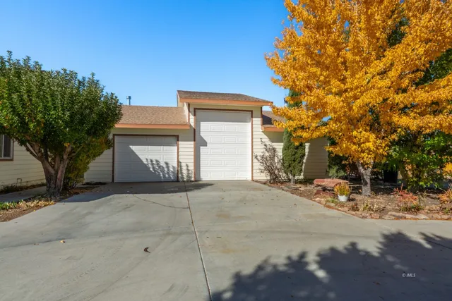 a view of a house with a yard and garage
