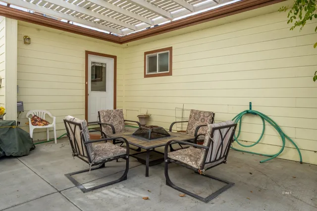 a view of a patio with couple of chairs