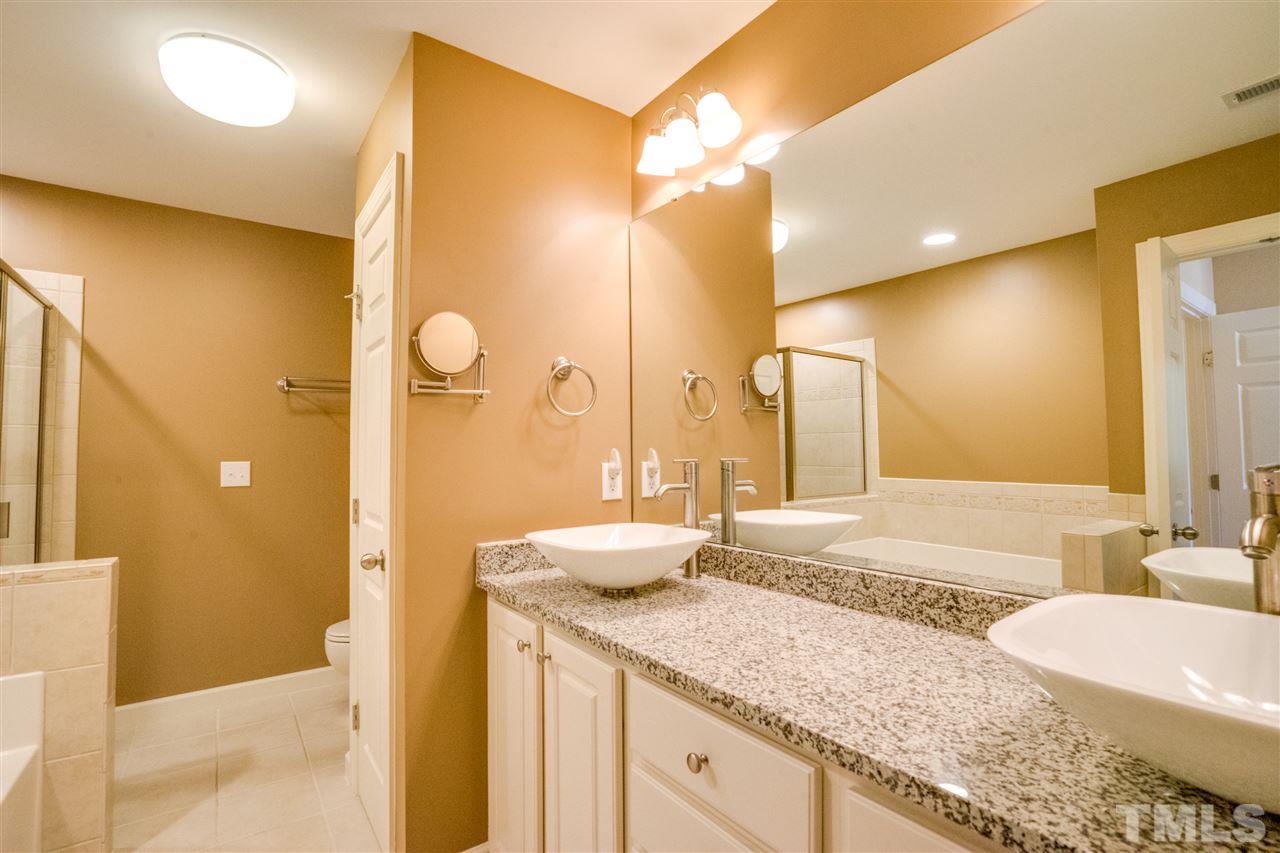 2303 Dunlin Lane Raleigh, NC 27614 - Photo 14 of 25 a bathroom with a granite countertop sink and a mirror