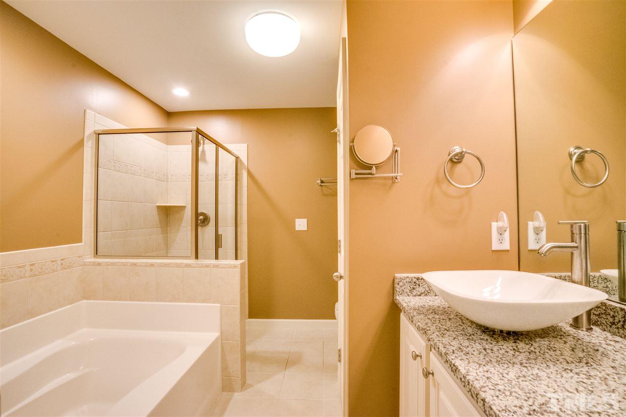 2303 Dunlin Lane Raleigh, NC 27614 - Photo 15 of 25 a bathroom with a granite countertop sink and a mirror