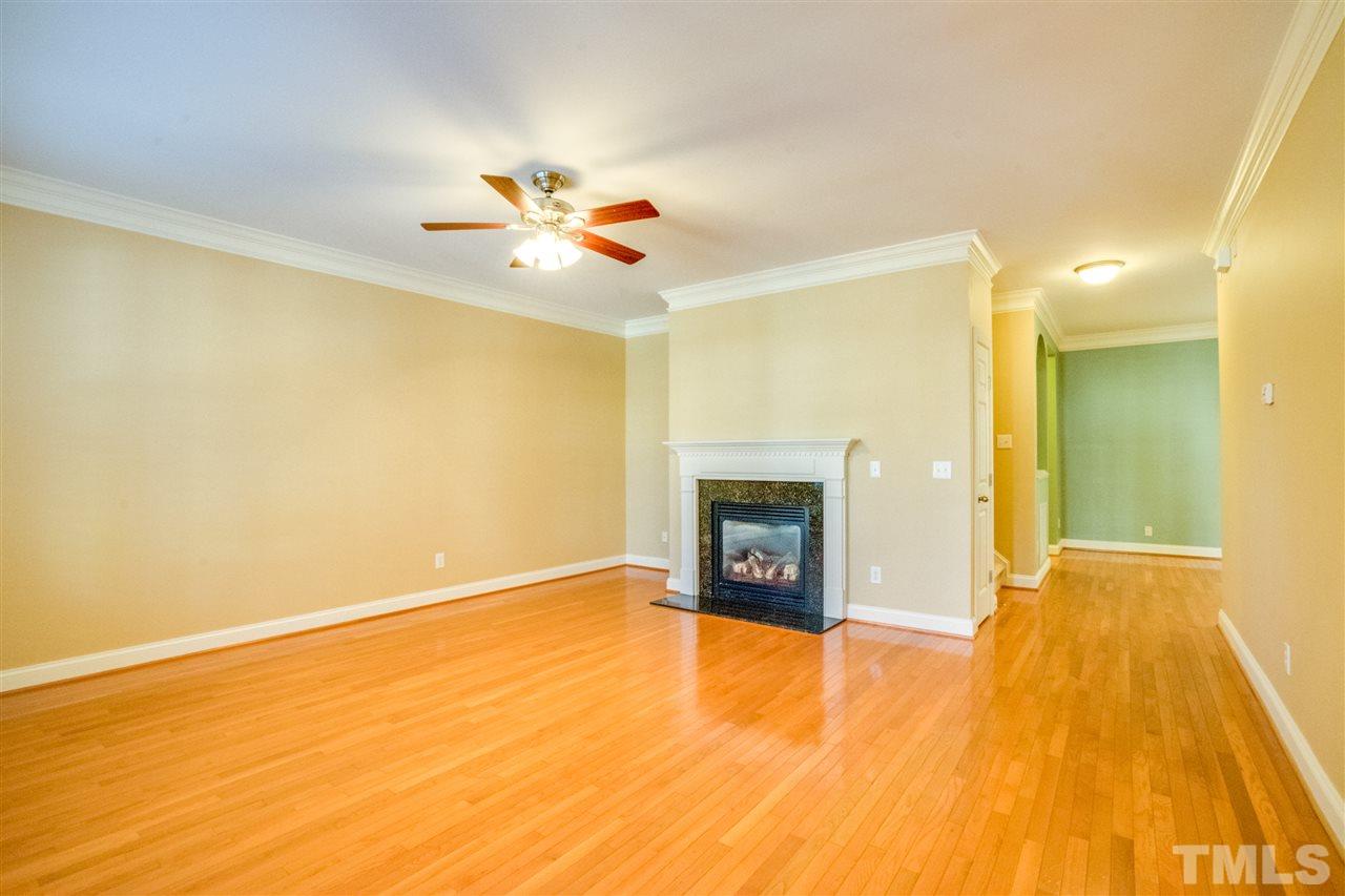 2303 Dunlin Lane Raleigh, NC 27614 - Photo 4 of 25 a view of an empty room with a fireplace and a window