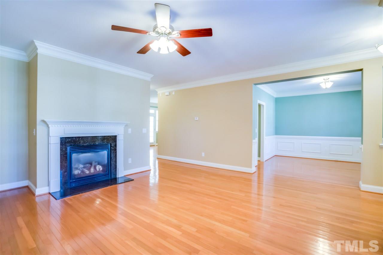 2303 Dunlin Lane Raleigh, NC 27614 - Photo 5 of 25 a view of an empty room with wooden floor fireplace and a window