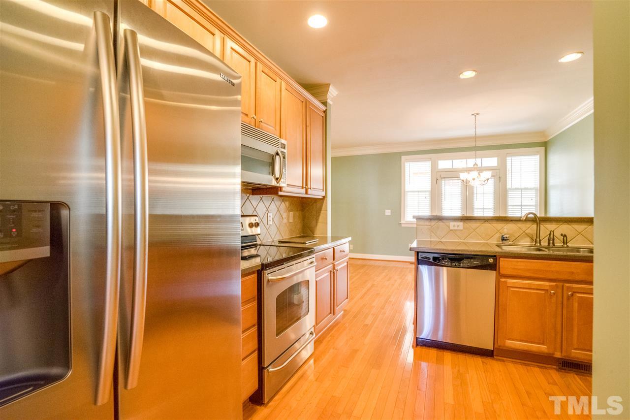 2303 Dunlin Lane Raleigh, NC 27614 - Photo 7 of 25 a kitchen with stainless steel appliances granite countertop a refrigerator a stove and a sink